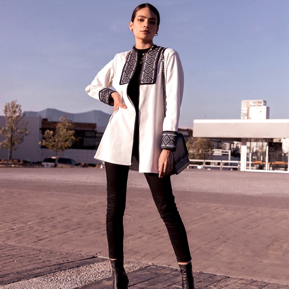 White long jacket with black universe patterns embroidered.